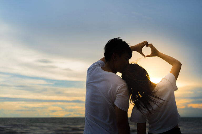 couple making heart with hands